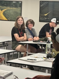 Rea in class on Family day with Jackson sitting next to her.