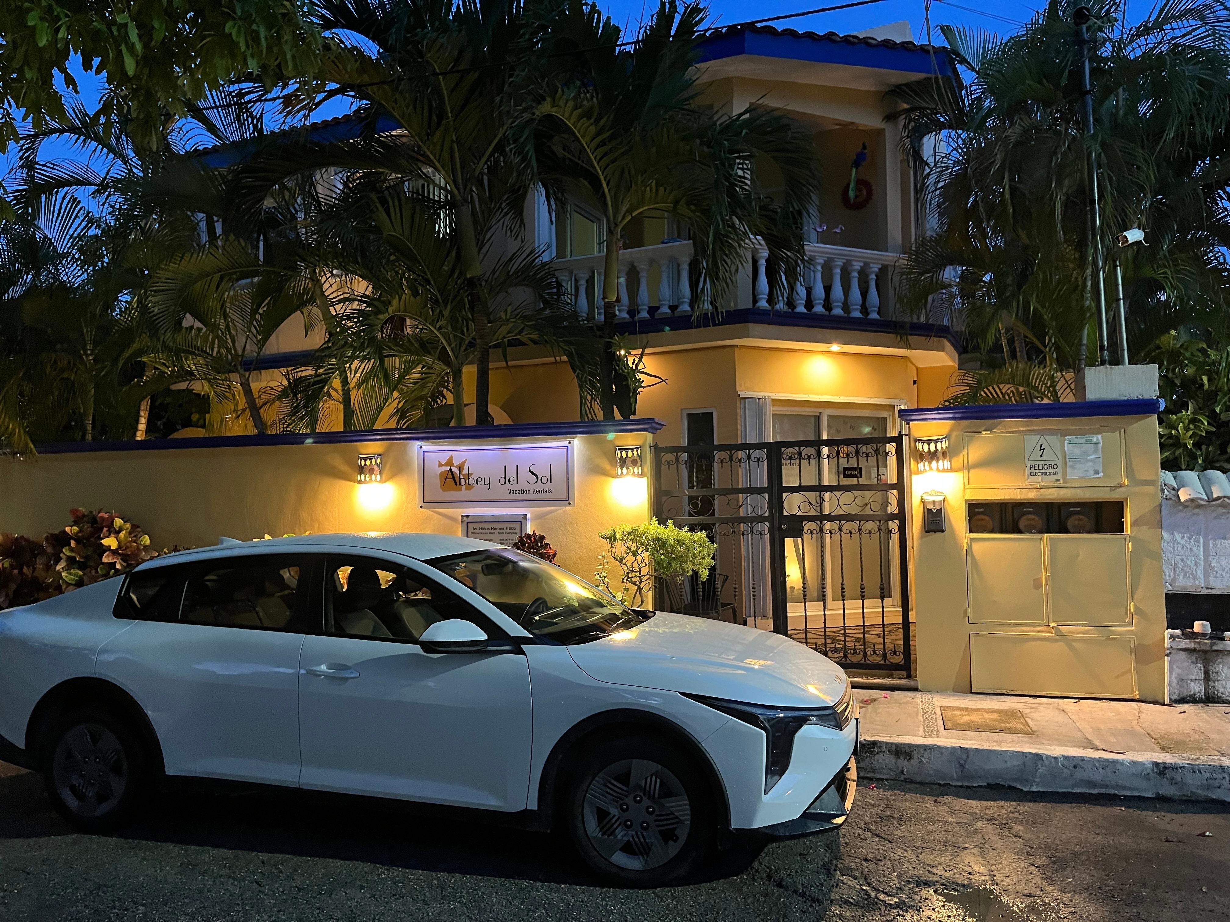 The car I slept in after traveling all day. The beautiful property I could not enter in the background.