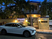 The car I slept in after traveling all day. The beautiful property I could not enter in the background.