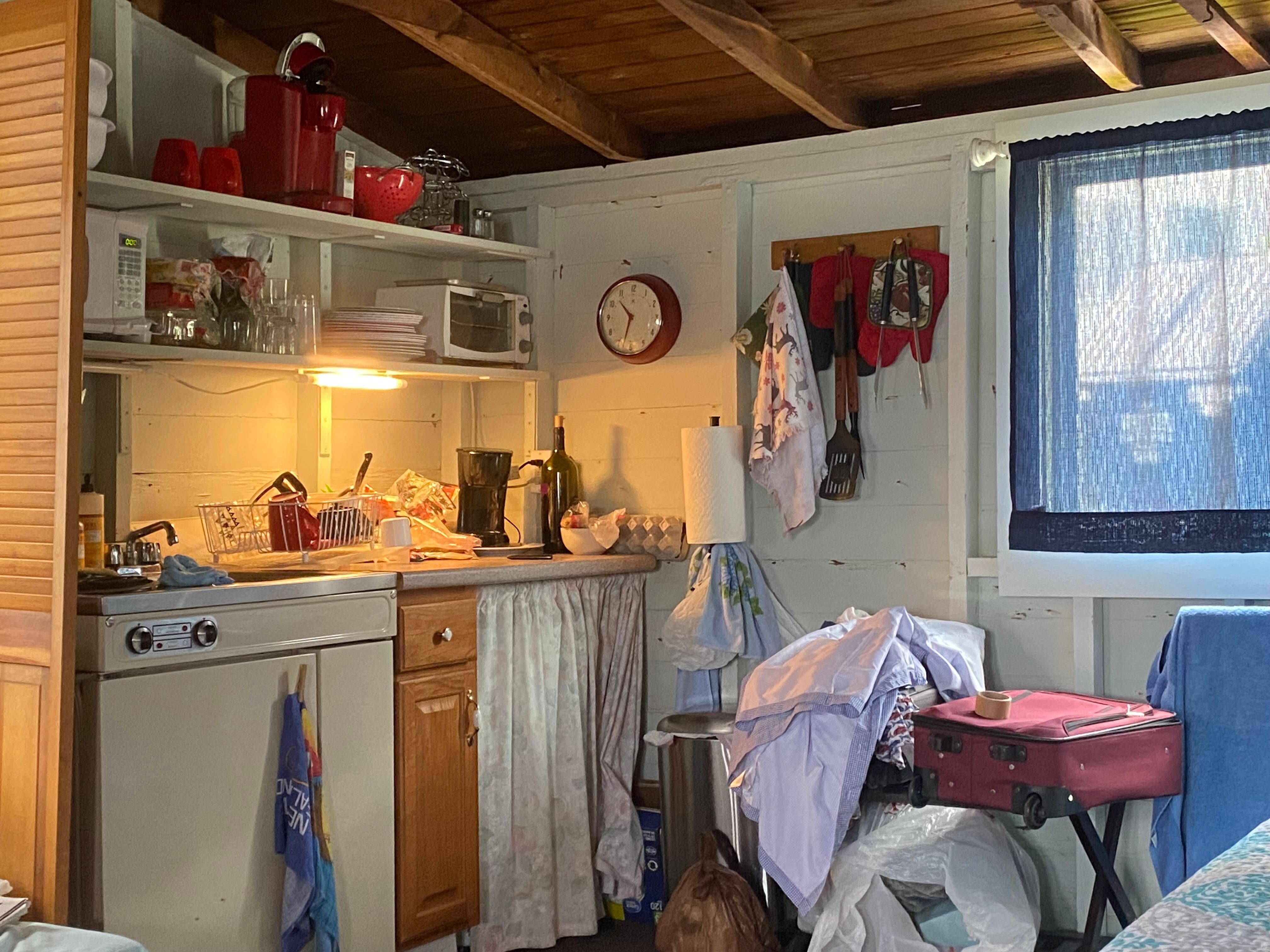 A 5 ft. food prep space w/college size fridge, sink, 2 burner stove. Sorry but not much room for suitcases.