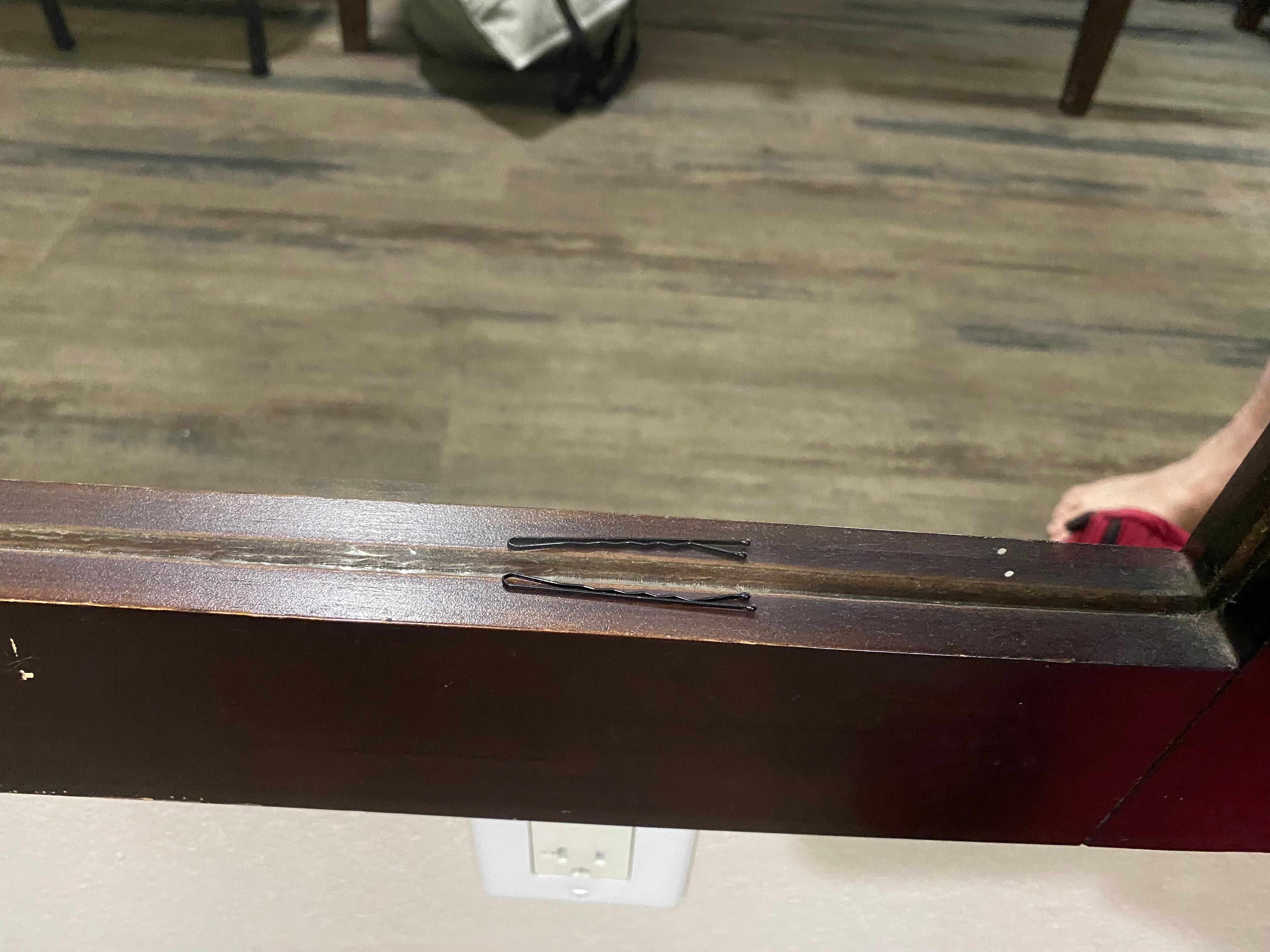Previous person’s Bobby pin on mirror ledge.