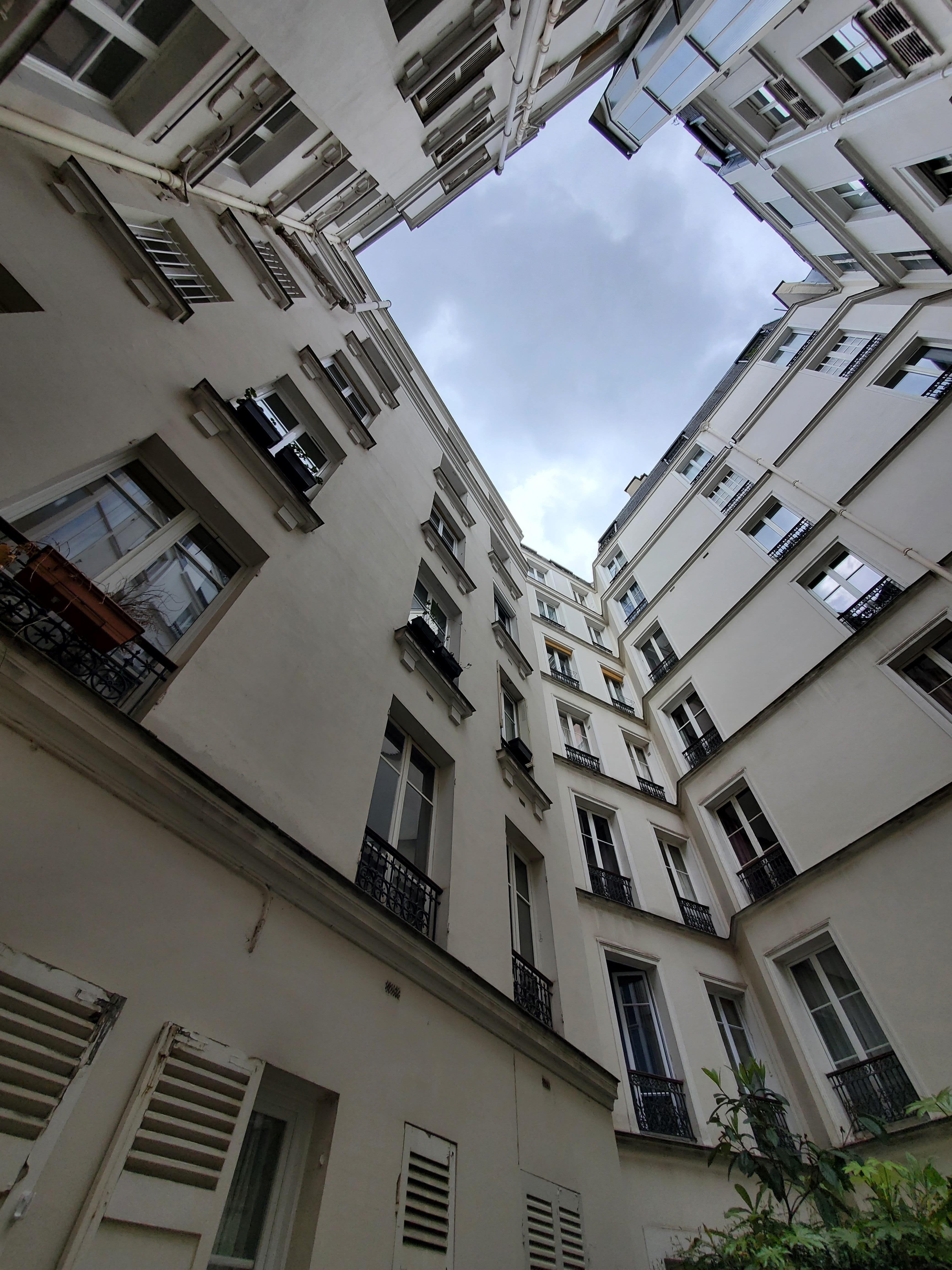 Inside the building,  looking up. 