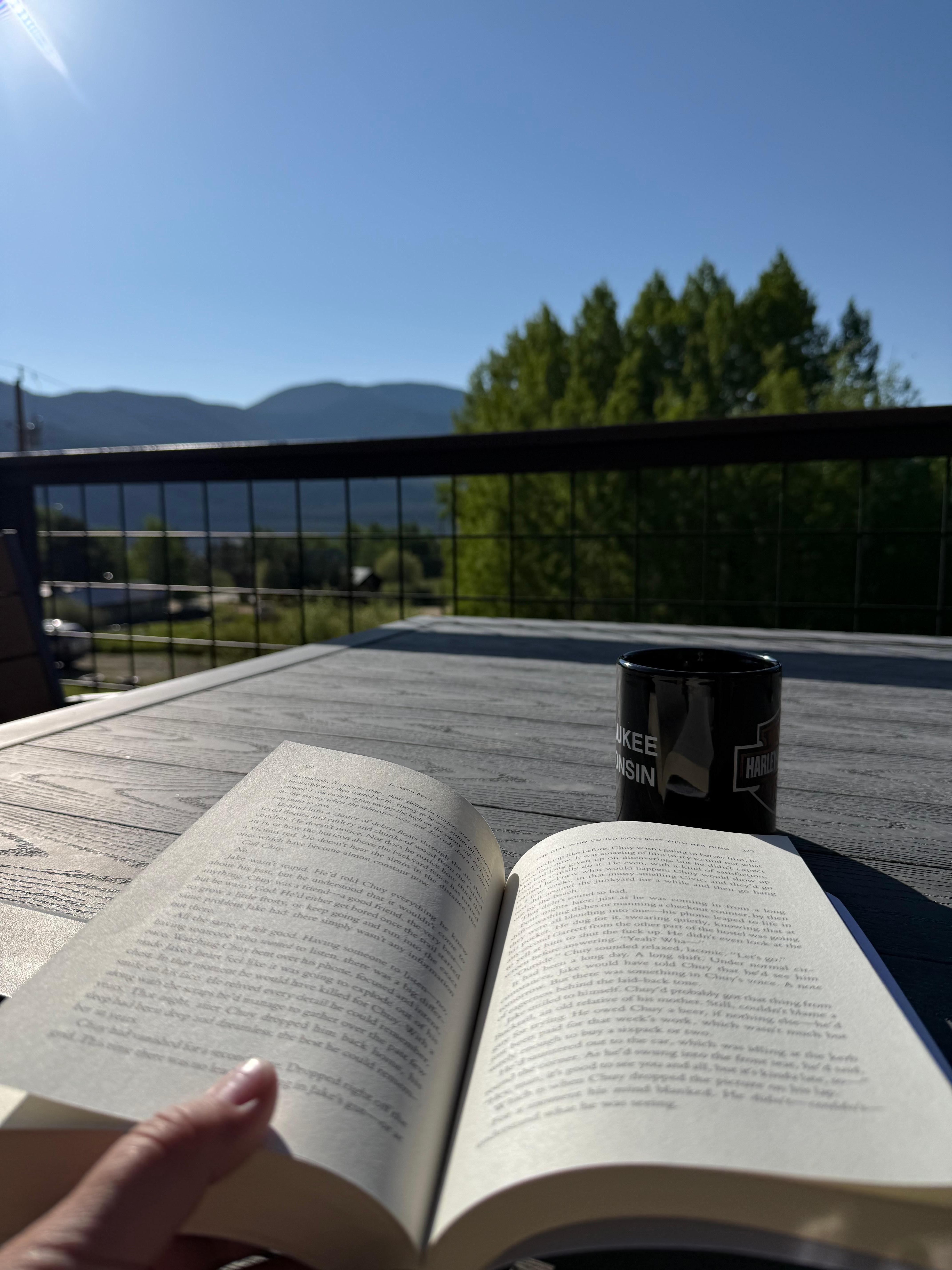 My favorite way to spend the morning - reading on the deck with a cup of coffee and this amazing view! 