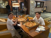 Kids playing games and having a good time sharing a pizza @ Tenaya