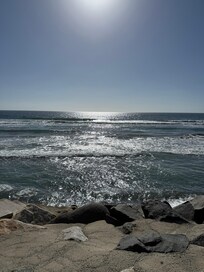 Beautiful views but this is the beach back yard with only rocks below. Not beachfront