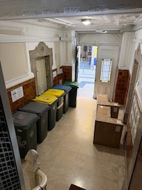 Entrance to building also stores their trash. They didn’t show this in the listing photos.