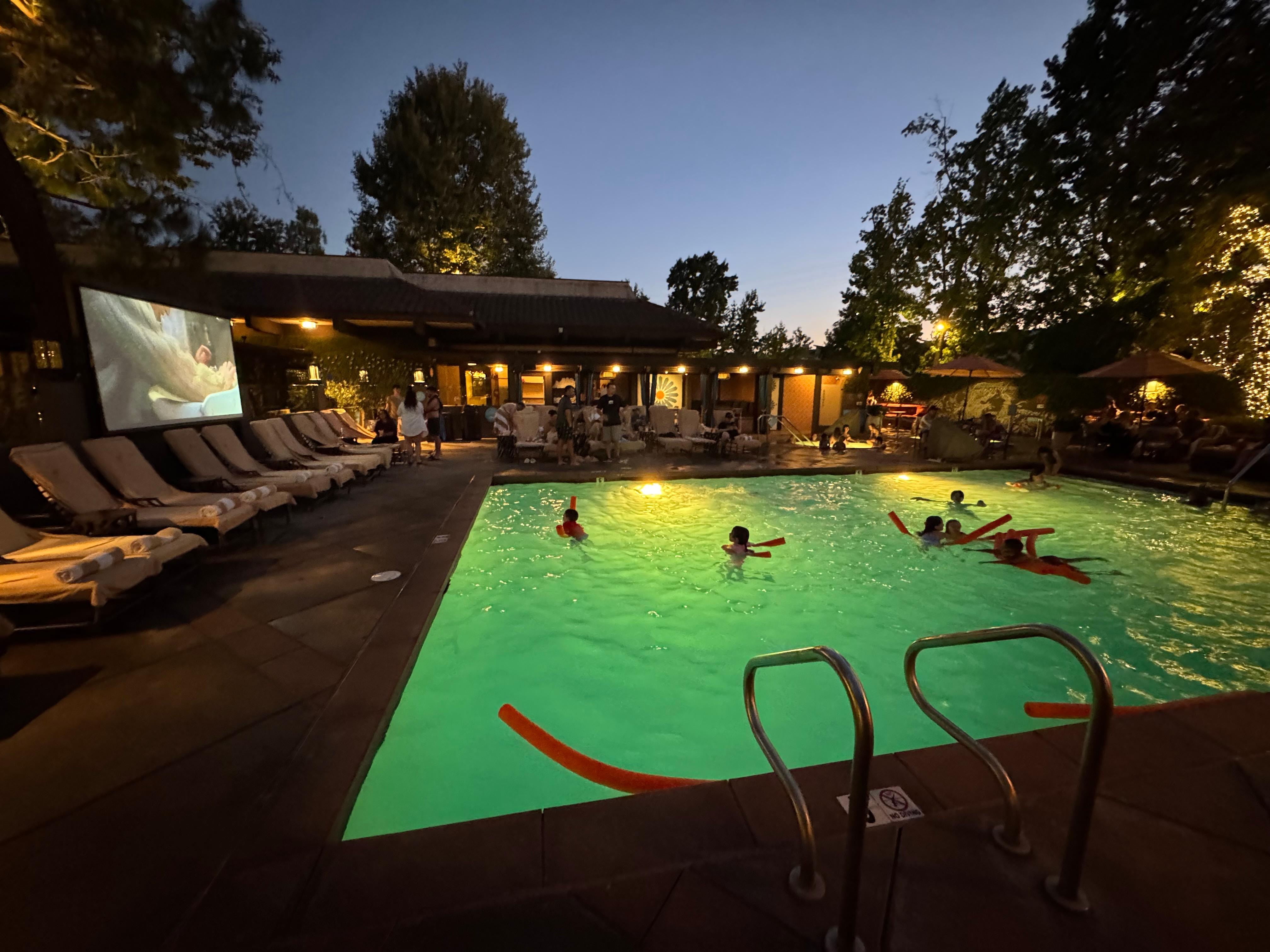 Pool with movie at night. 