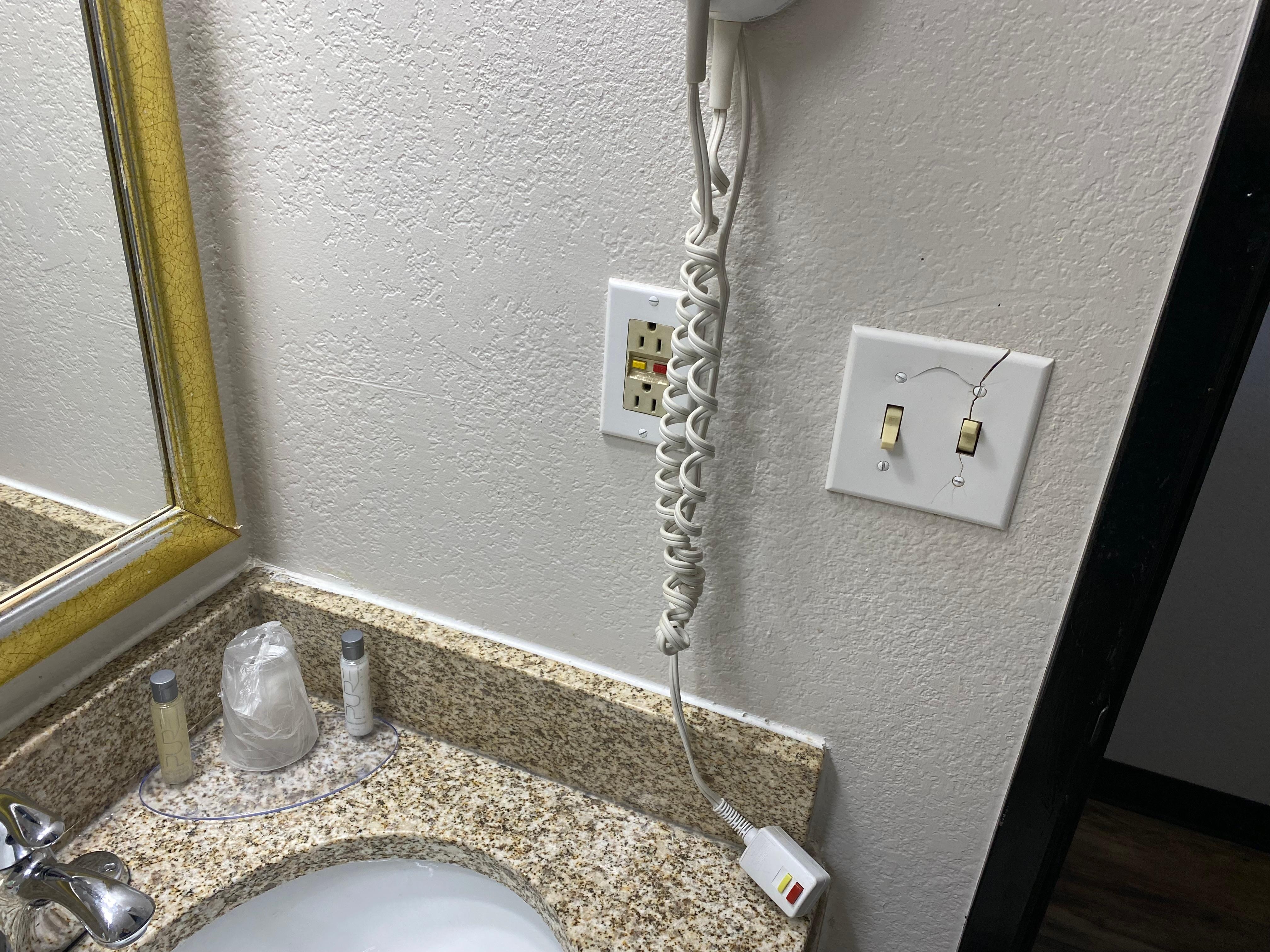 Bathroom Picture 1: Note the cracks in the wall light panel.