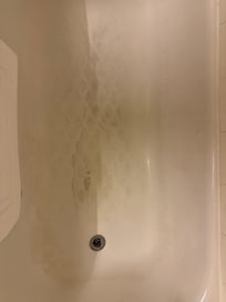 Bath floor. This is soap scum built up from not scrubbing