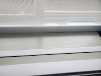 Torn curtain blind upon entering room