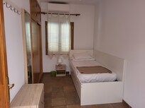 One of the single bedrooms with a huge wardrobe and air conditioning