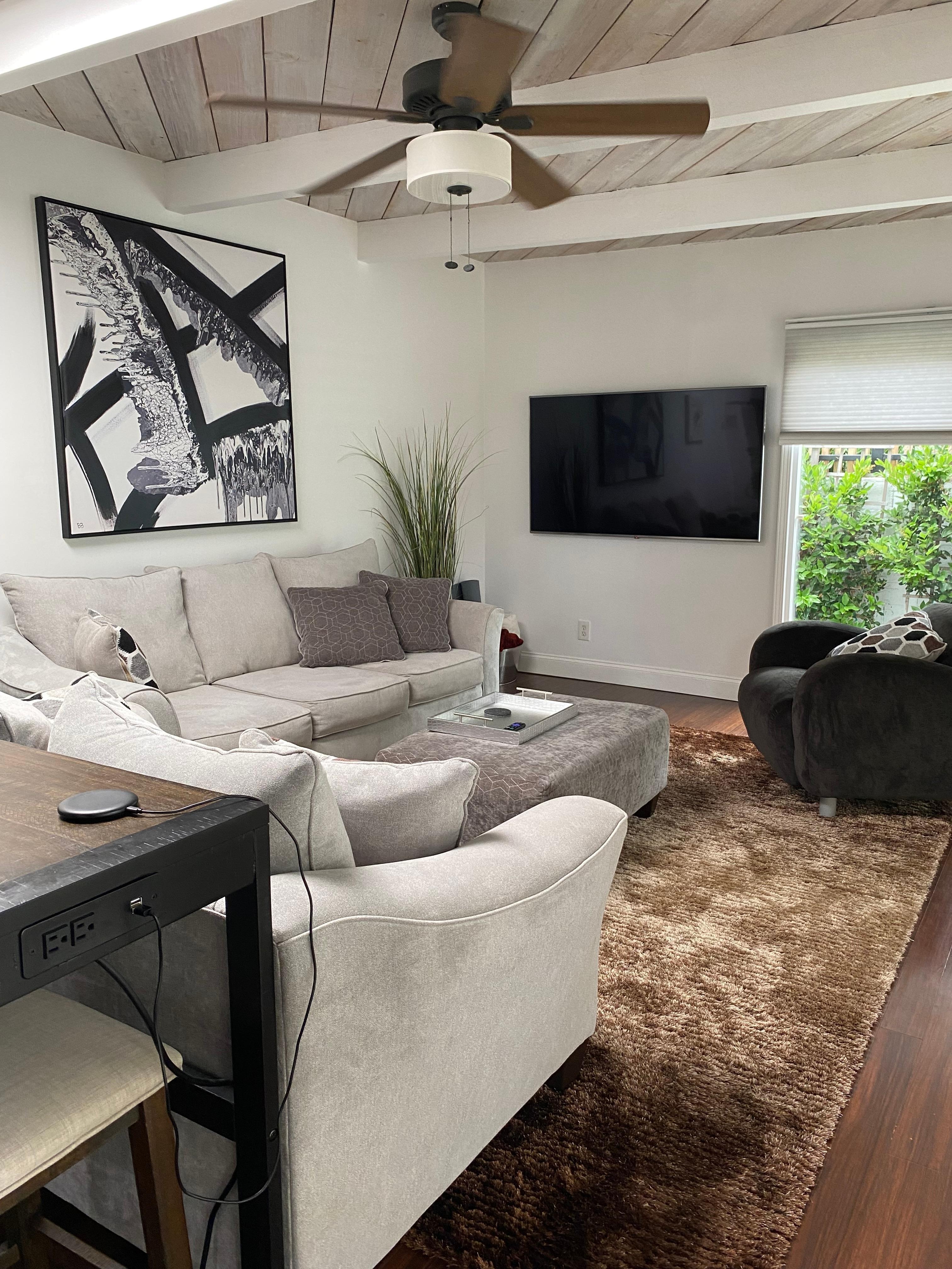 Comfy living room with a wall of sliding glass doors to admire the greenery 