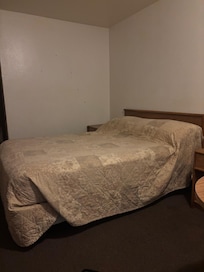 Bed poorly made, holes in wall, gross carpet