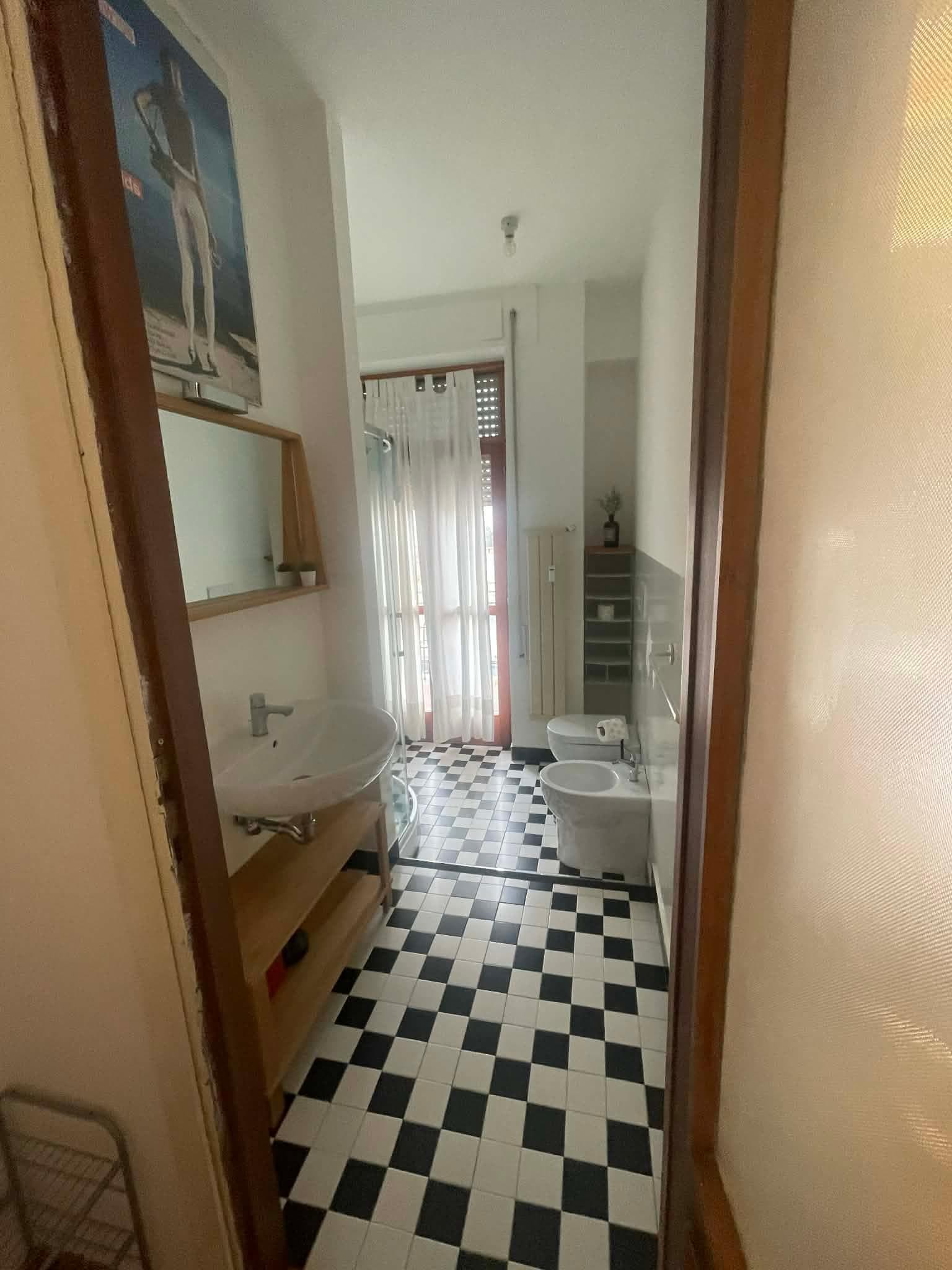 Bathroom with doors that open to shared patio from the kitchen