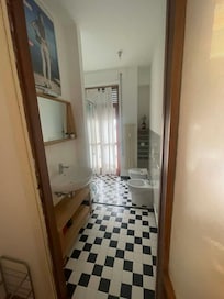 Bathroom with doors that open to shared patio from the kitchen