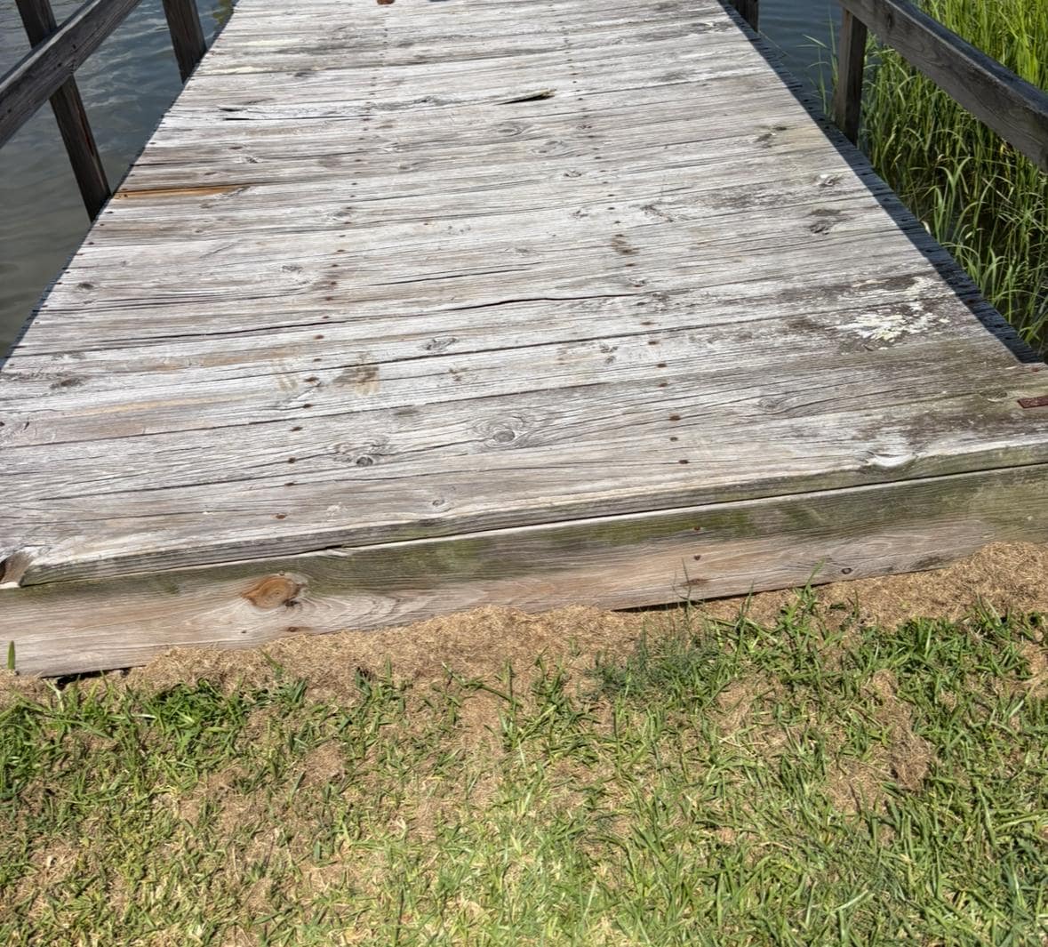 Uneven and lose board with large splinter toward the center(tripping hazard) 