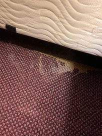 Edge of the bed. Don’t tell me that housekeeping did not see it.
