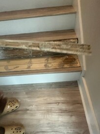 Several stair planks were already loose or separating, creating a safety hazard. After one family member slipped on a raised plank, a stair plank completely detached, making the fall both dangerous and distressing.