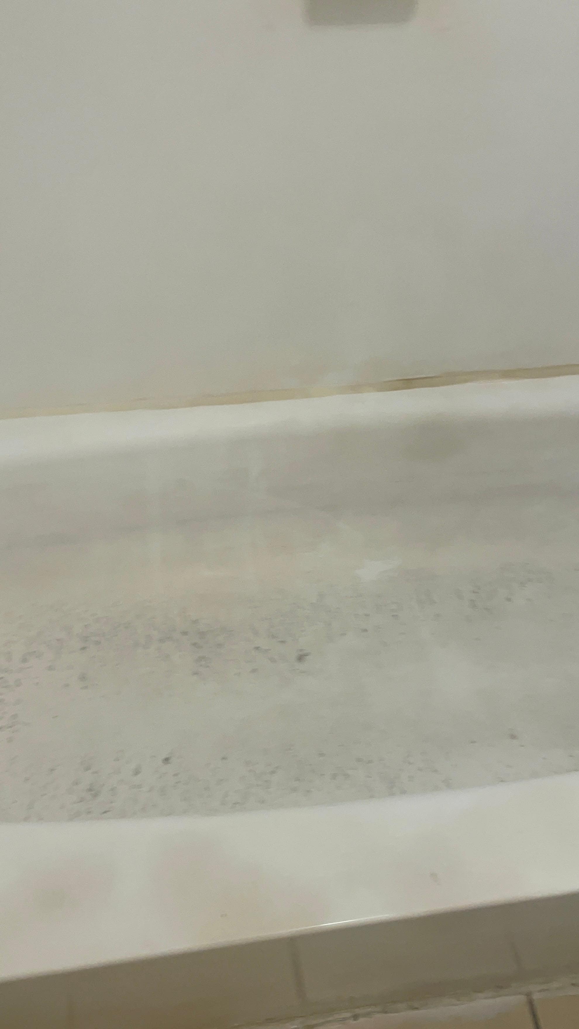 The walls and tub were brown black and yellow. The shower curtain was black and yellow 