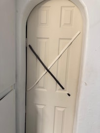 A whole door closed off with mounting tape and hand writing