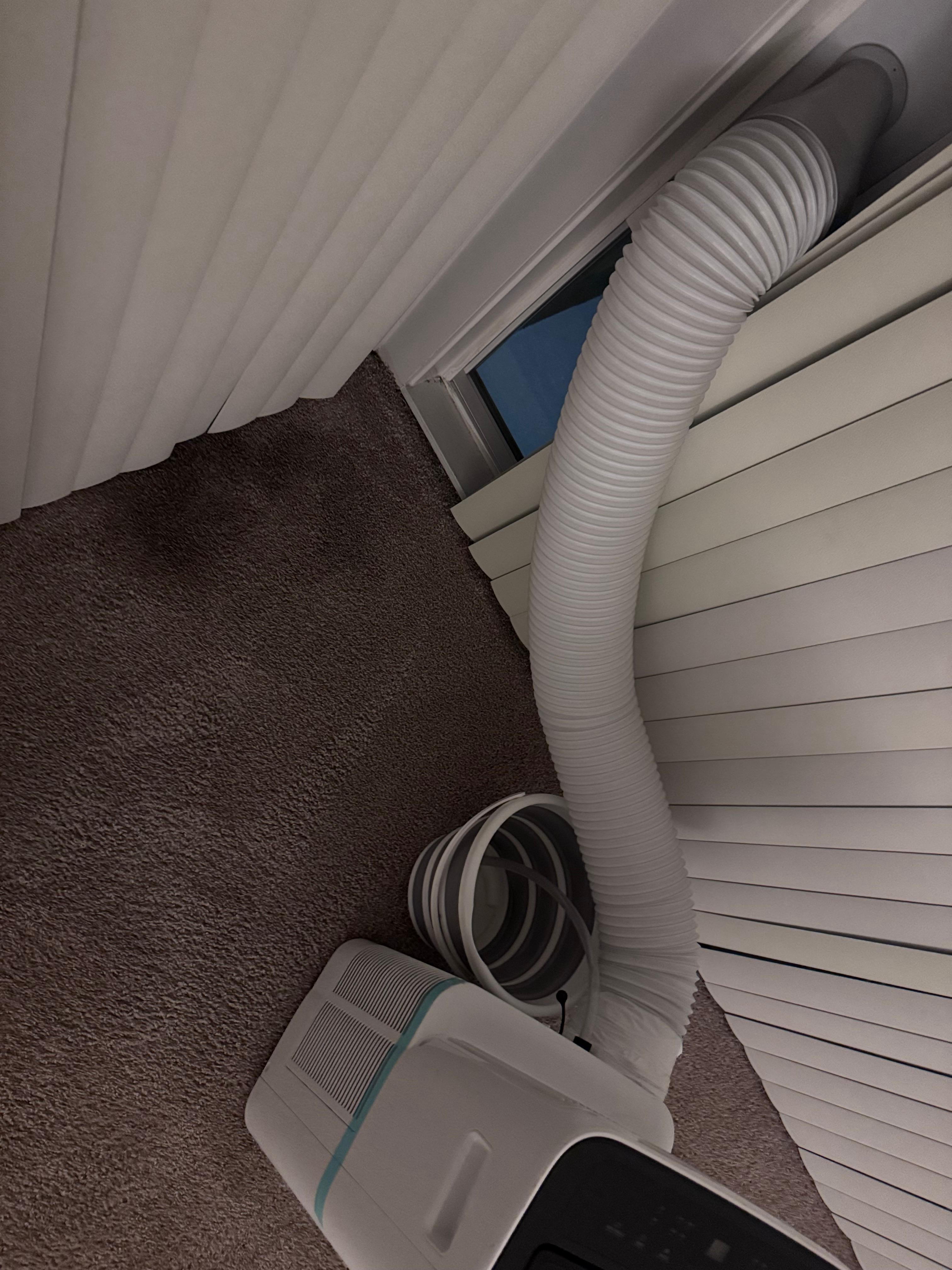 Portable ac unit, not central AC. Mold on carpet. Hole in window/screen to outside.