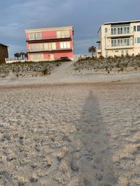 Dune going up to access gate to cross the street to the house