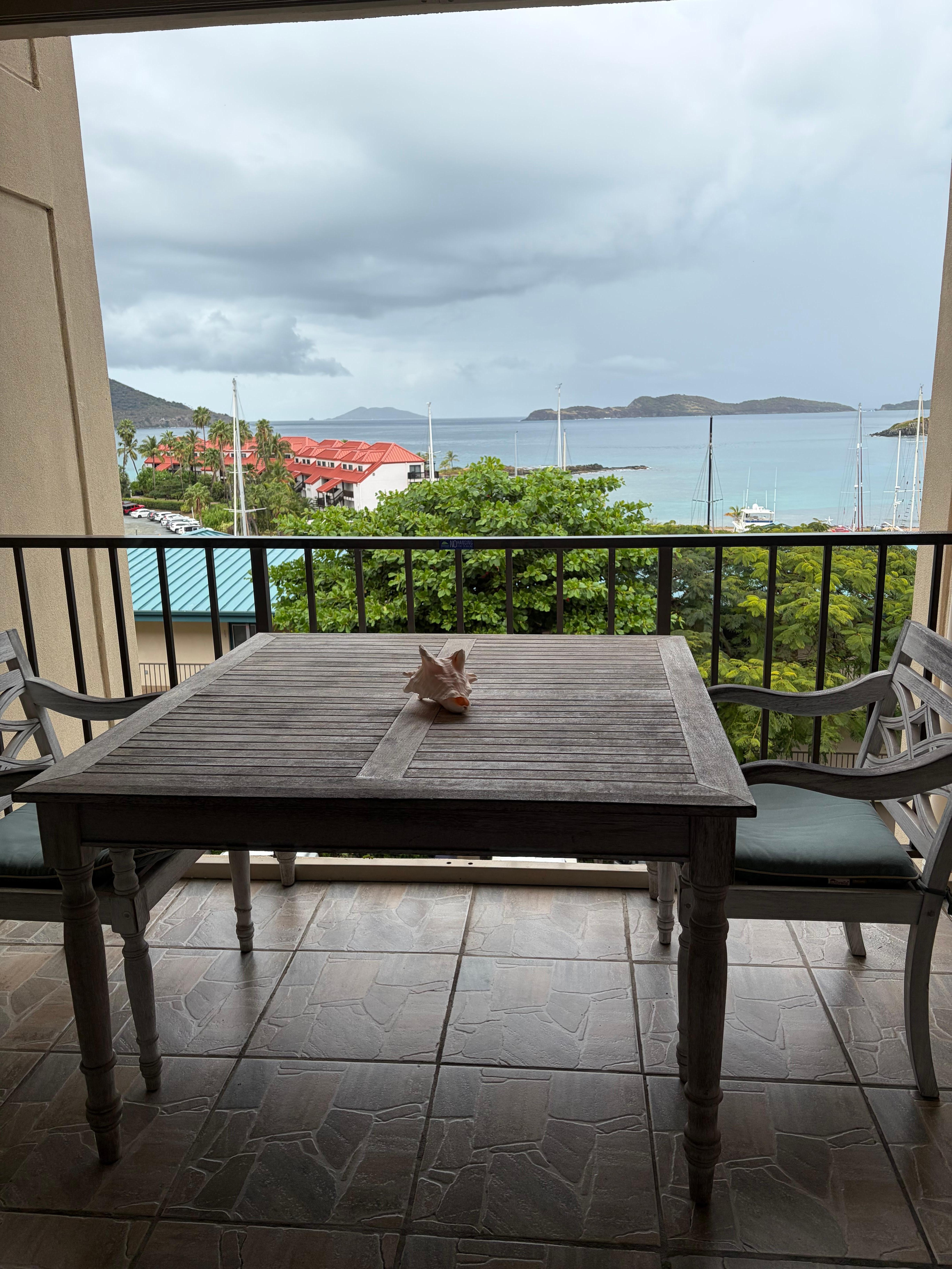Balcony with very large table. Could use a clothes drying rack for wet towels and swimsuits. 
