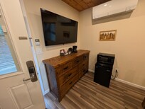 Refrigerator and tv and small trashcan