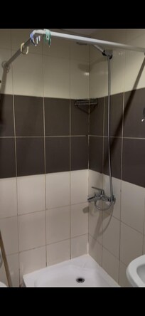 Shower - no shower curtains but there was a dated squeeo