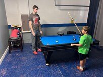 Guys enjoying the game room.