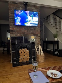 This is the front part of the open downstairs. This is the living room, with the dining room and kitchen behind the old fireplace.