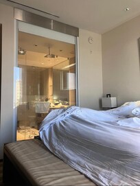 There is a blind that can be lowered to
Block the view from the bed into the bathroom.