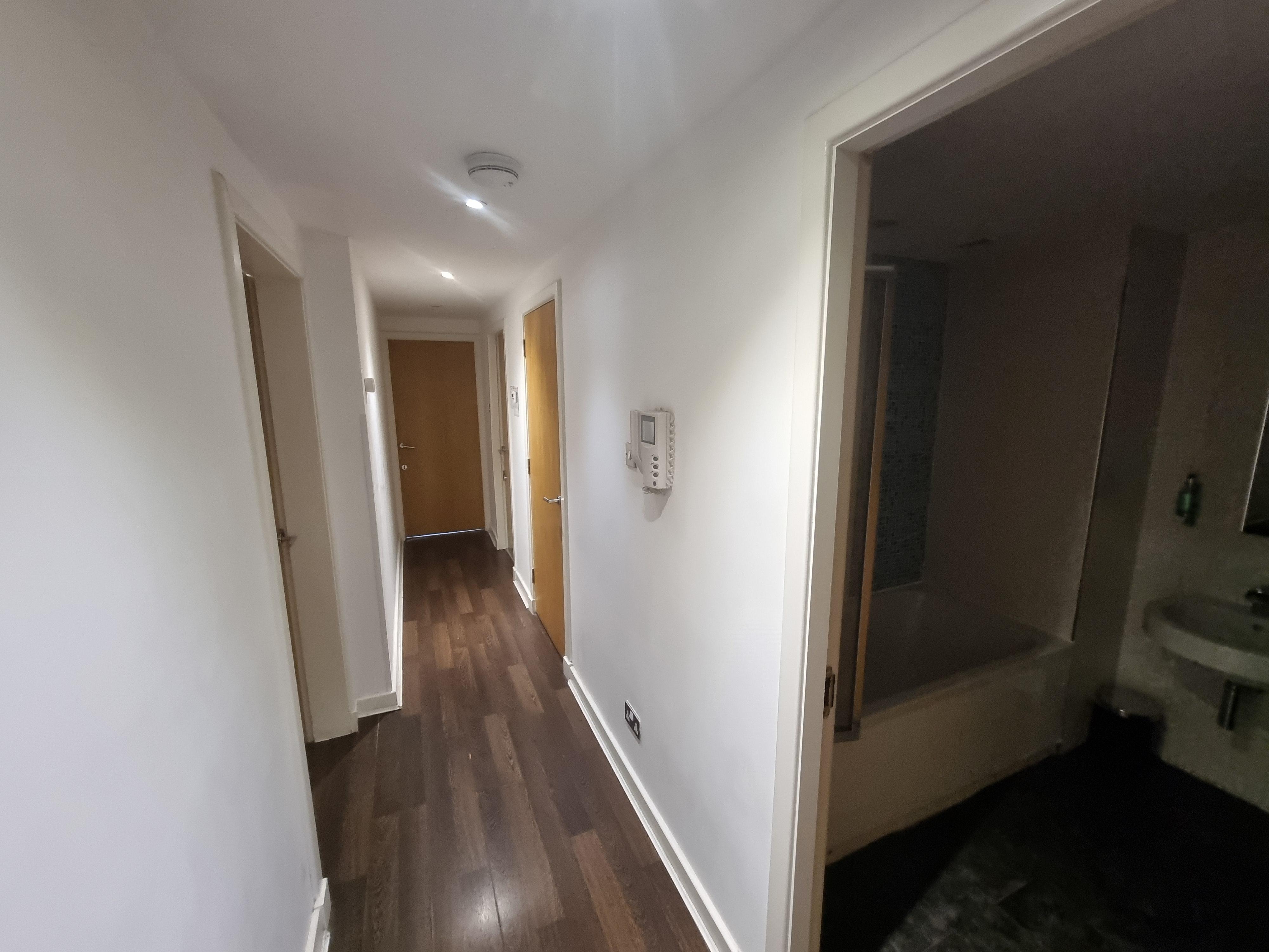 Hallway of the apartment with the picture taken from the living room/kitchen door