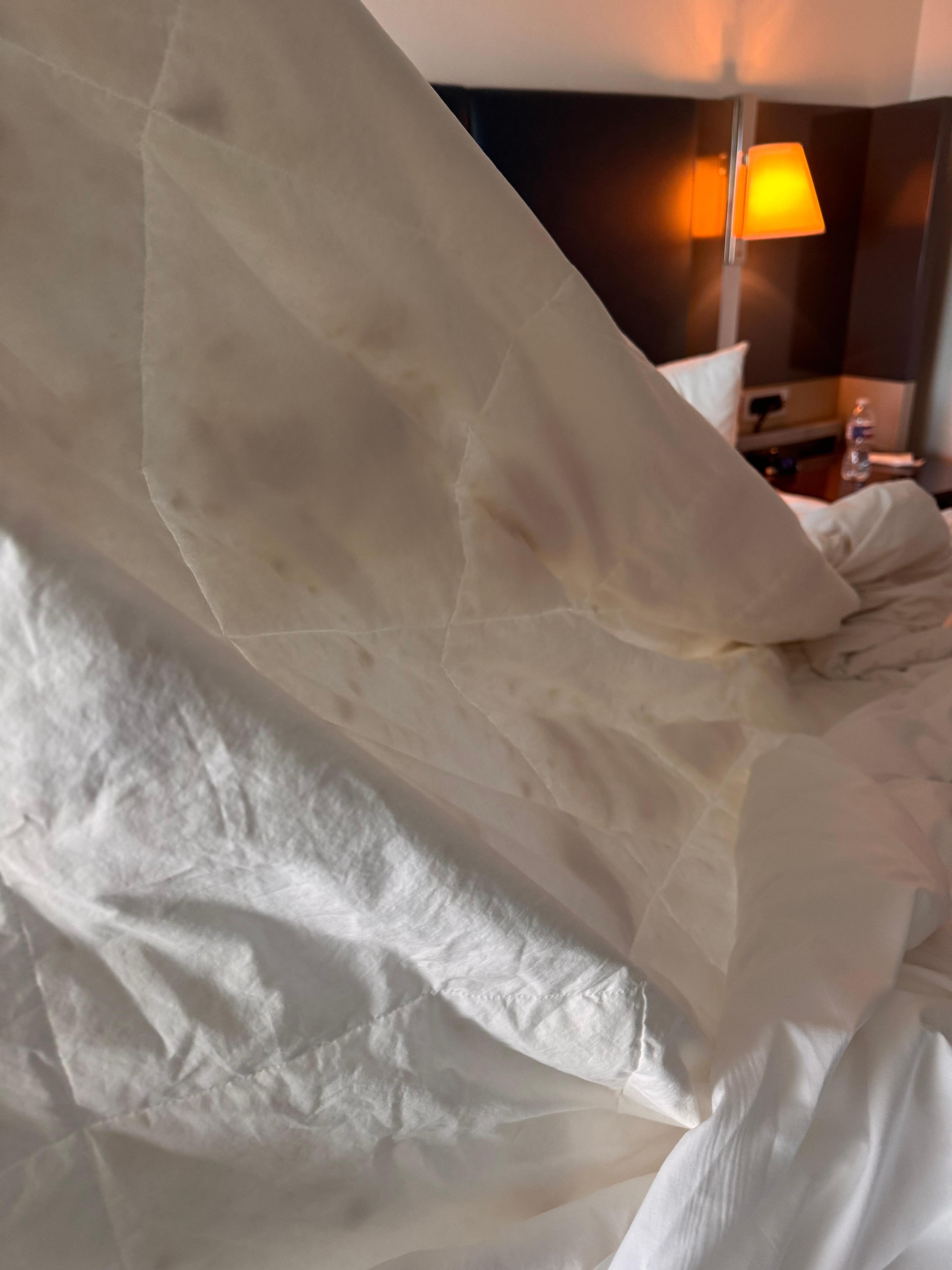 Blanket stained covered with two sheets 