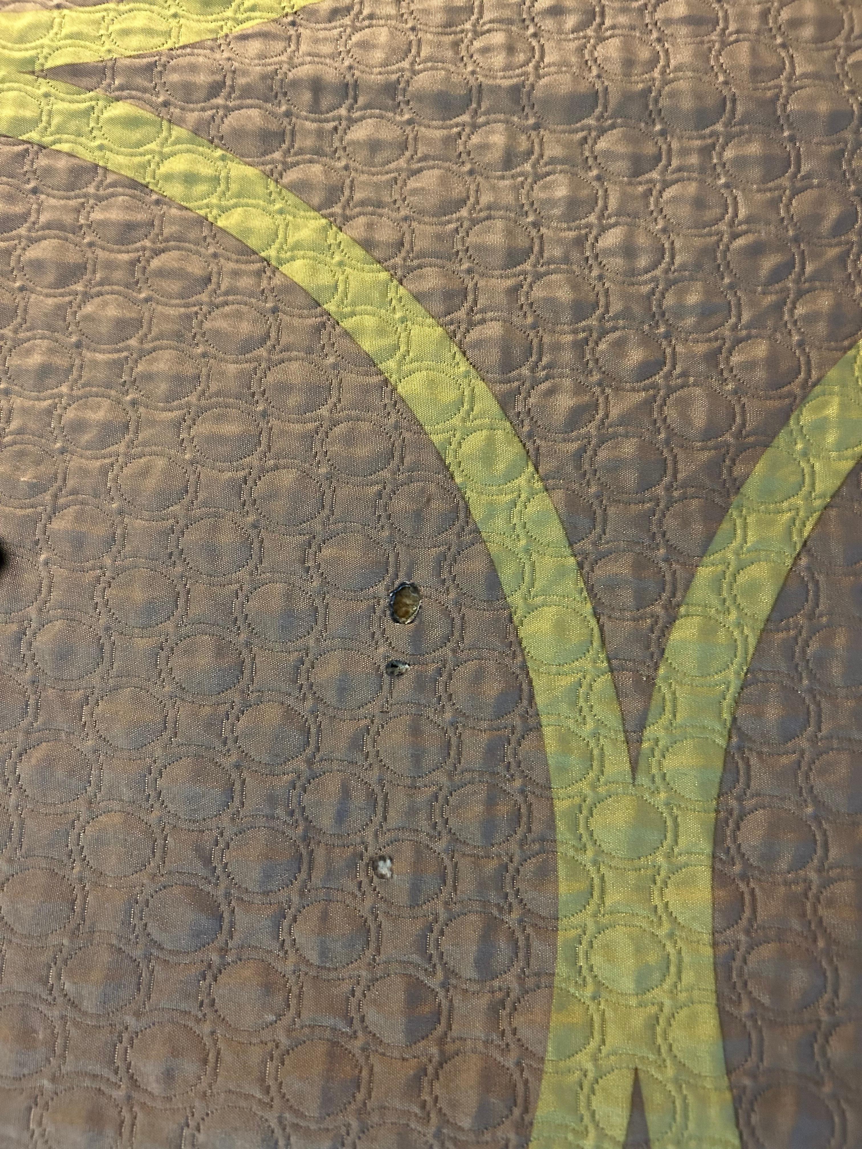 Bedspread with cigarette holes