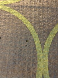 Bedspread with cigarette holes