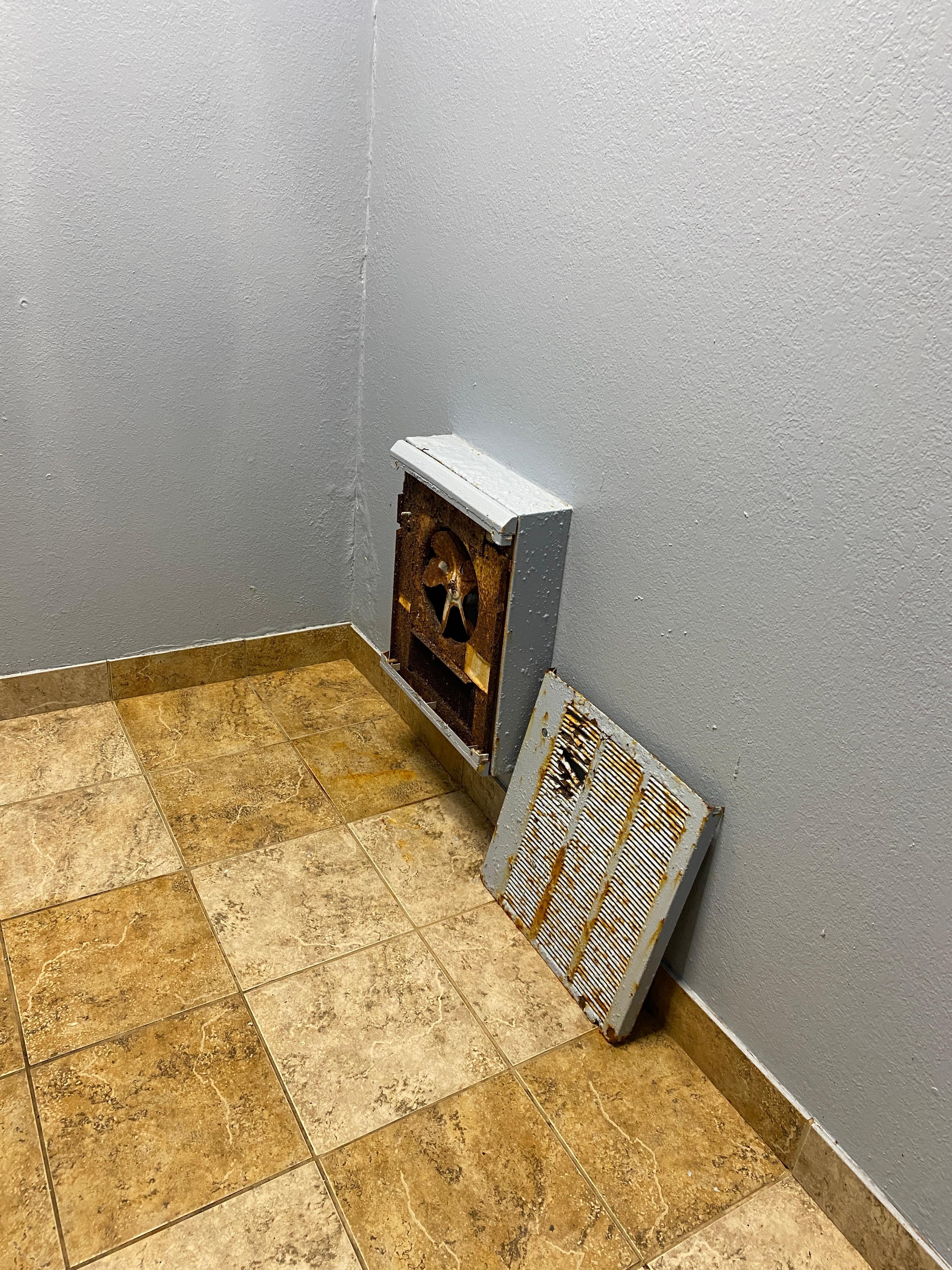 Rusty heater in pool area bathroom