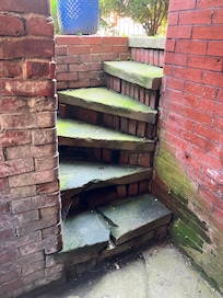 Steep stairs without a grab rail.
