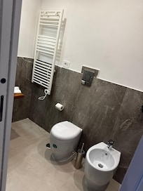 Roomi bathroom with standing shower. Just not place for your soap or shampoo