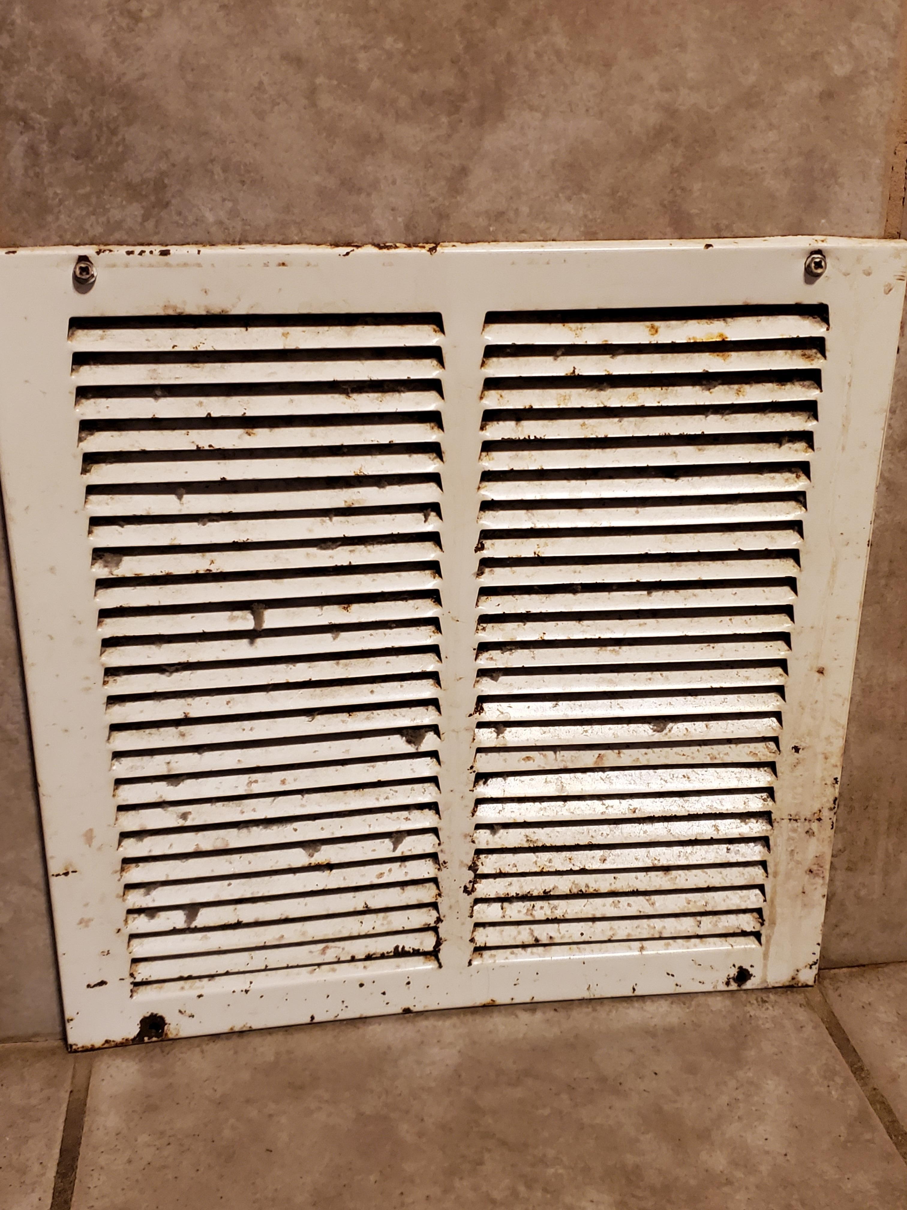 Rusted nasty vent on side of jacuzzi.