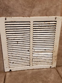 Rusted nasty vent on side of jacuzzi.