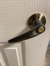 Bathroom door knob off center with finish completely rubbed of.