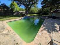 Concrete patio broken up and loose pieces everywhere.