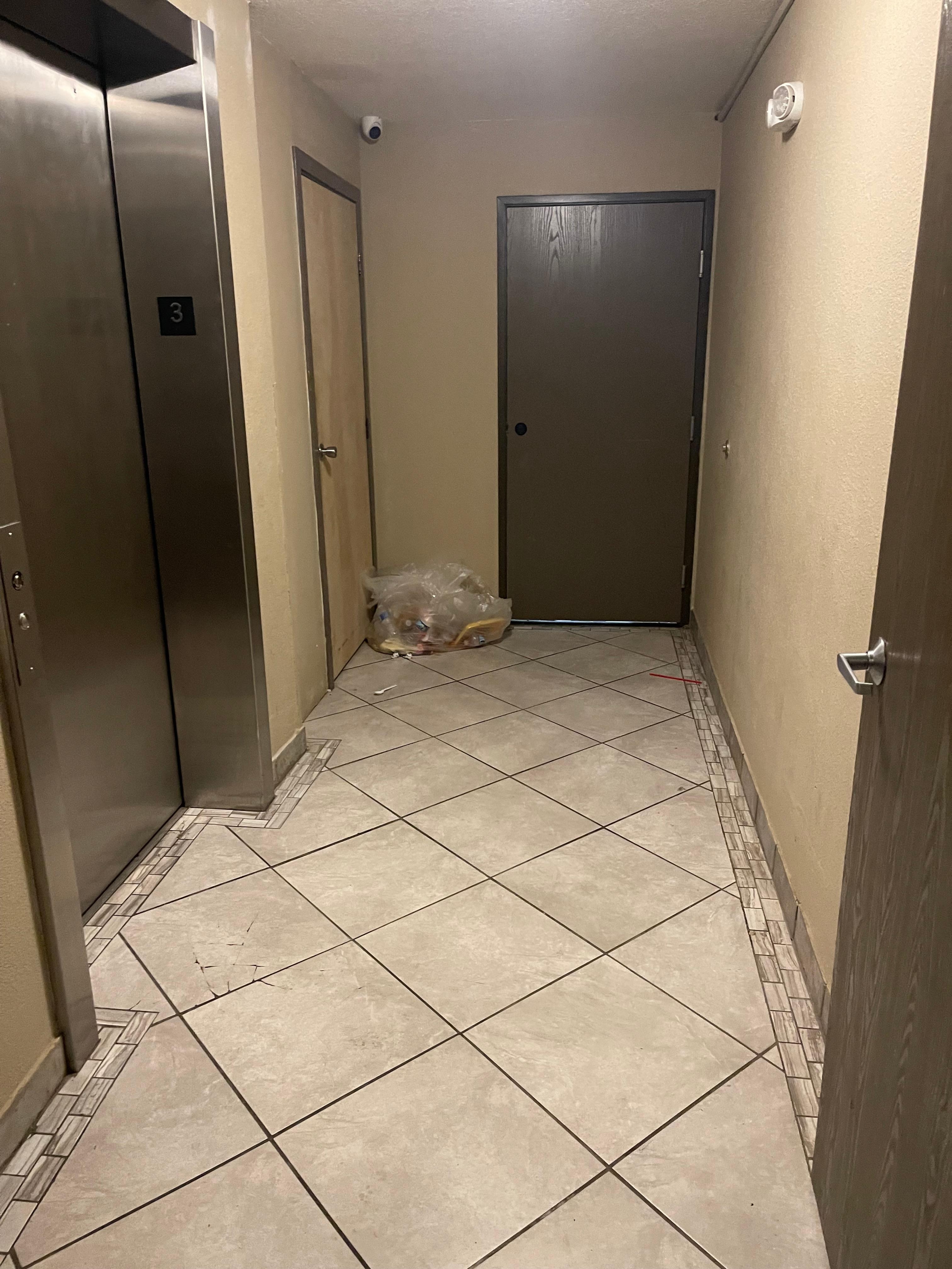 Garbage left in elevator lobby for a day and a half.  