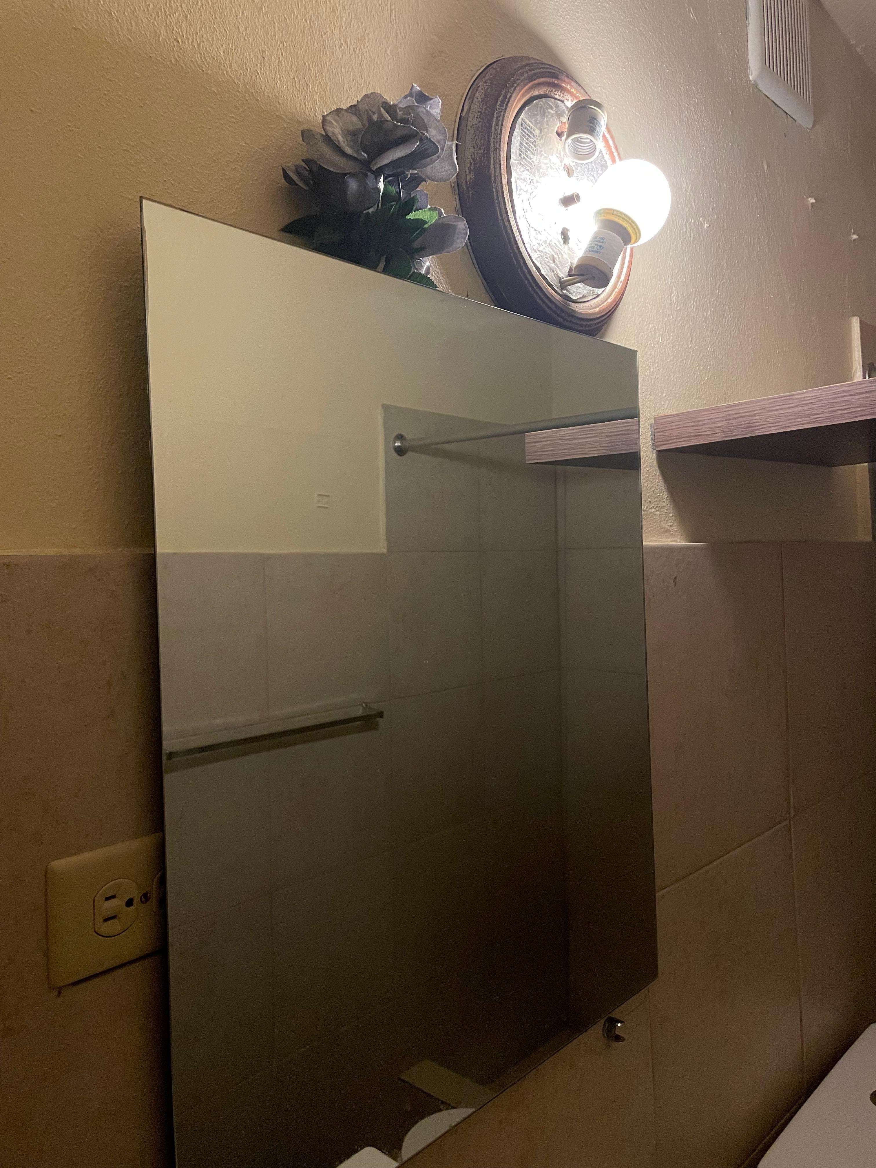 One bulb and a partially covered outlet 