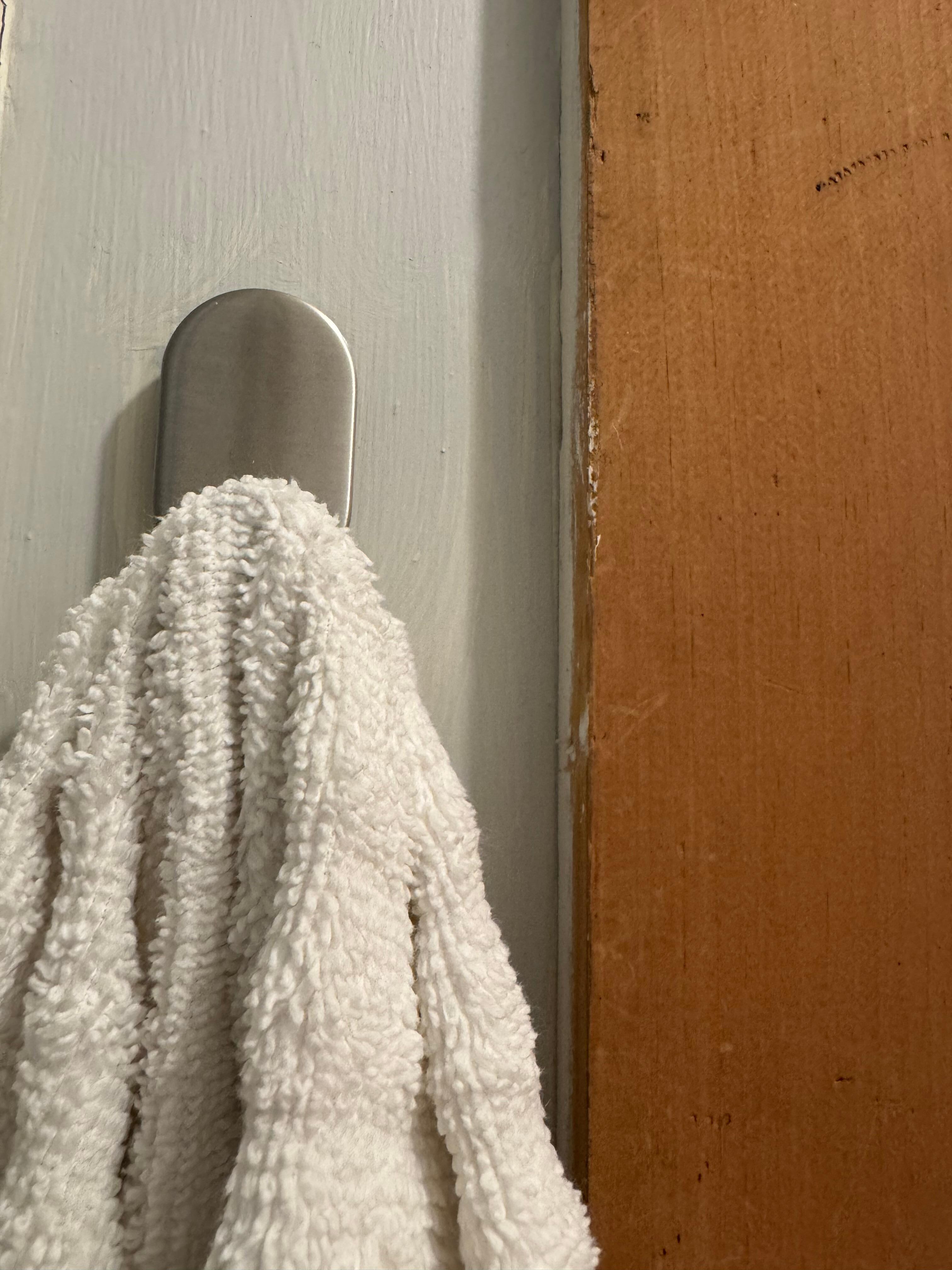 Hard to see, but the nail next to the towel hook. 