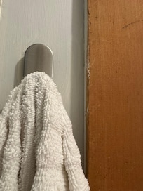 Hard to see, but the nail next to the towel hook.