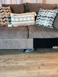 Other peoples clothes under couch in master