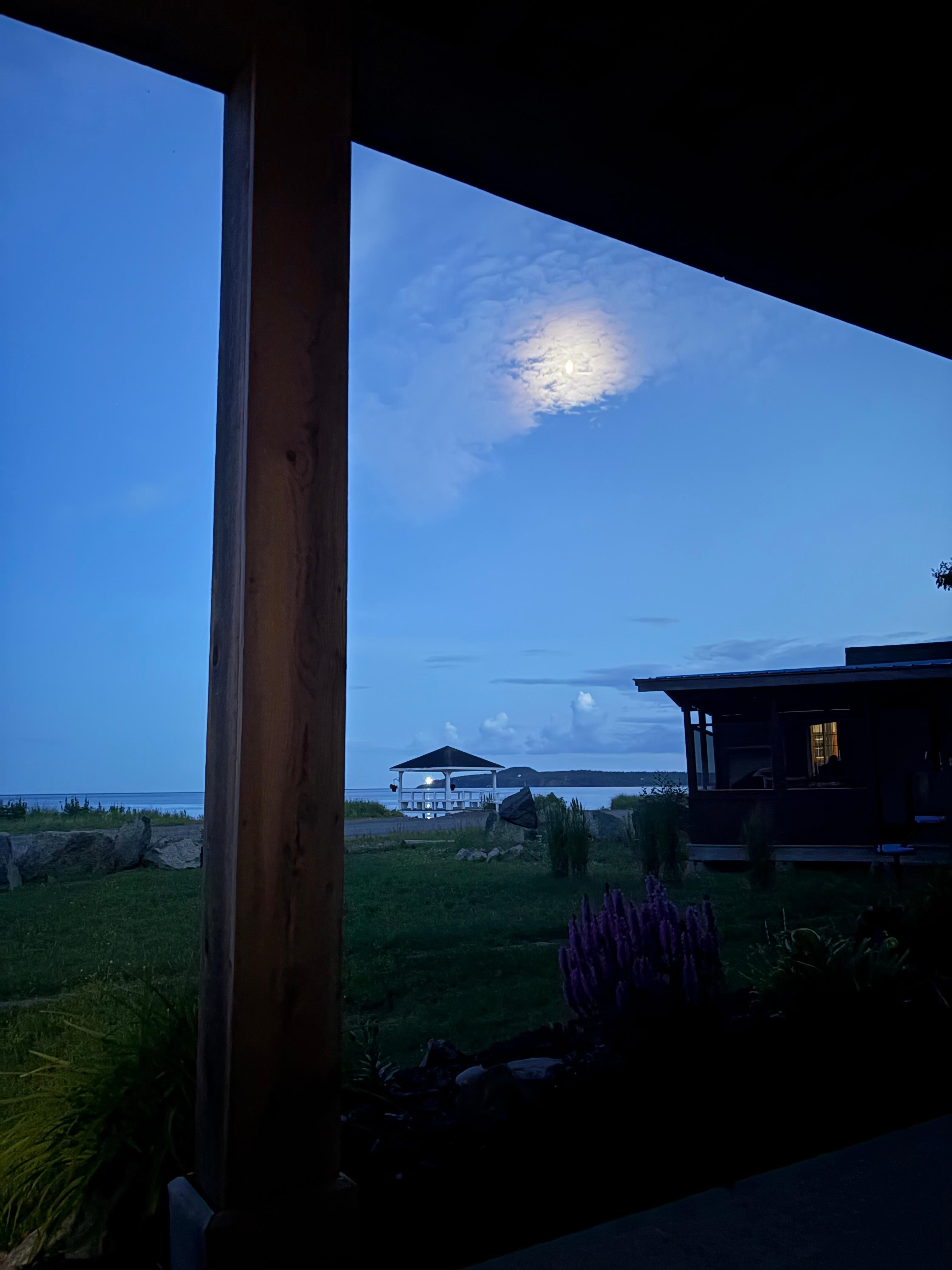Relaxing on the porch at night with the light house in the background.