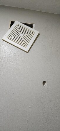 vent coming off wall, hole in wall (more holes but out of picture frame)